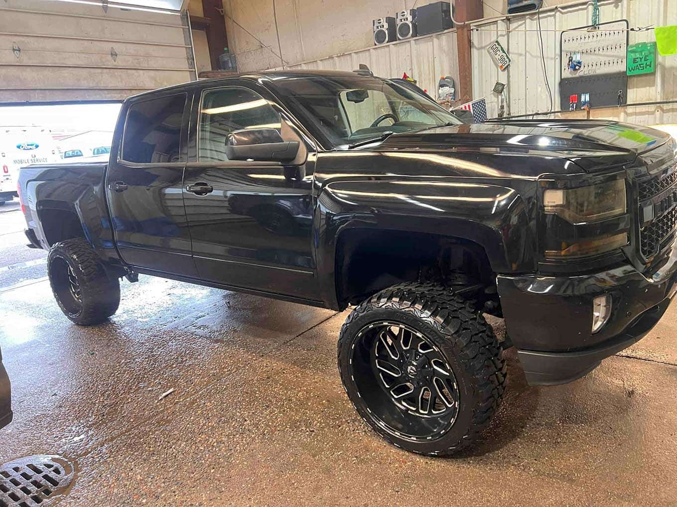 Home 28 Black lifted truck with custom wheels