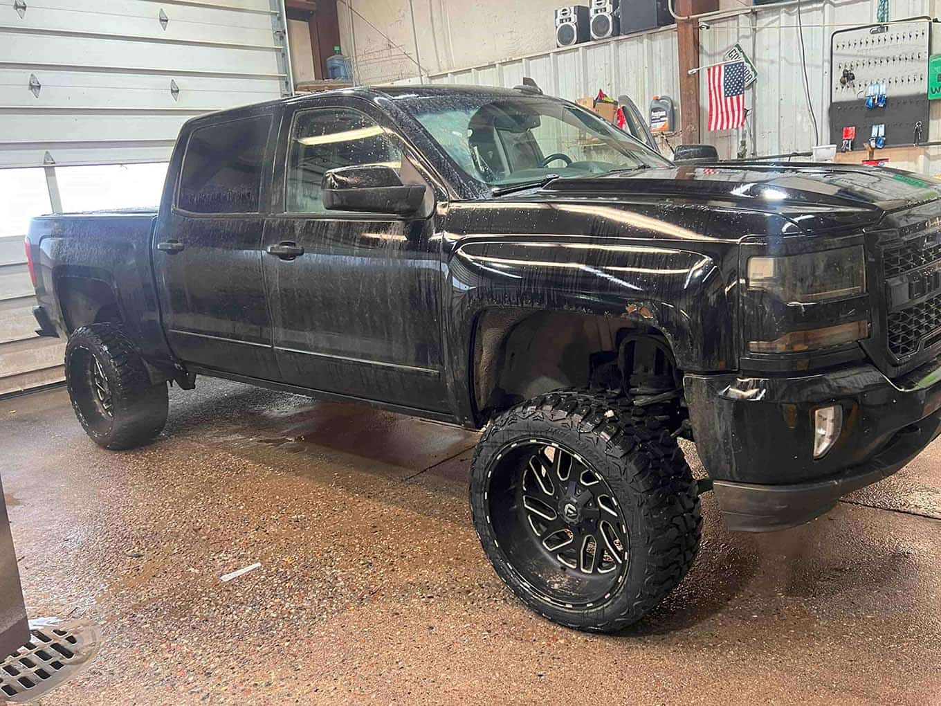 Home 27 Black lifted truck with large wheels