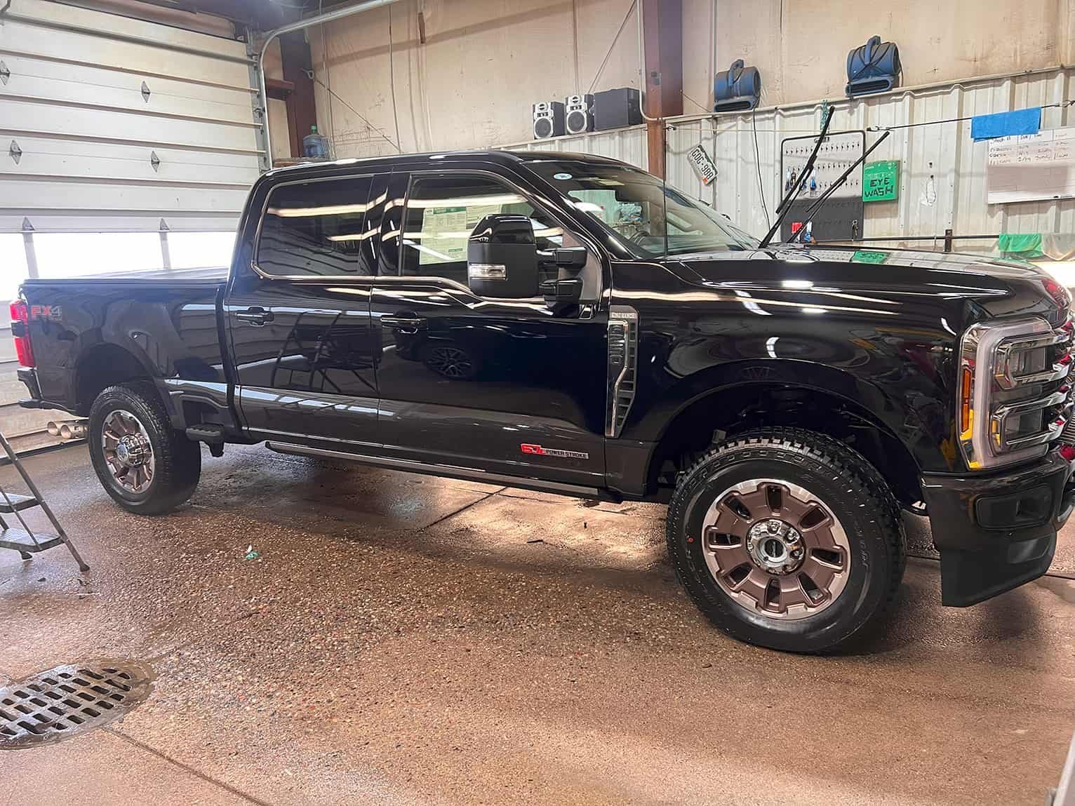 Shiny black pickup truck in garage