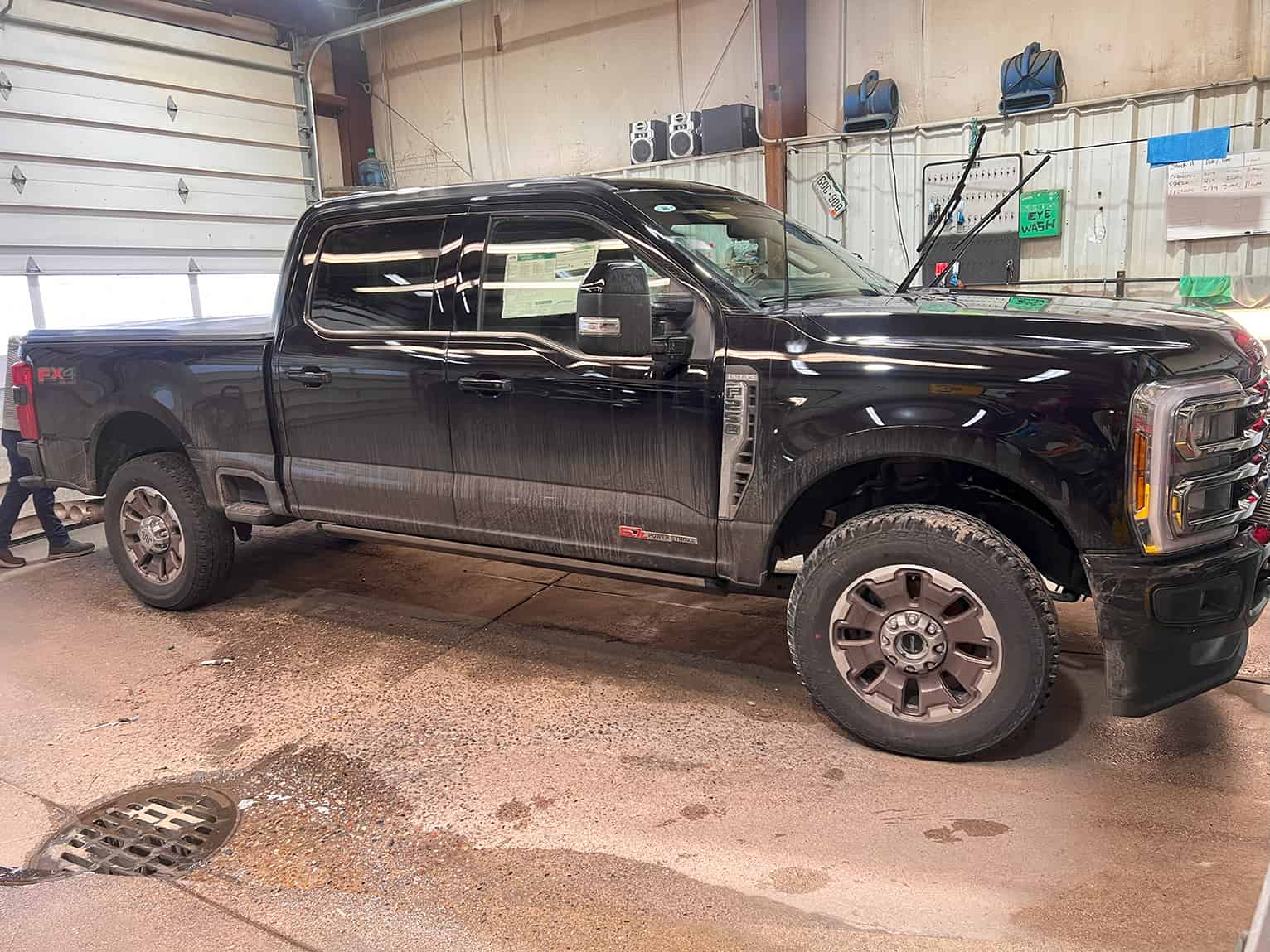 Dirty black pickup truck in garage